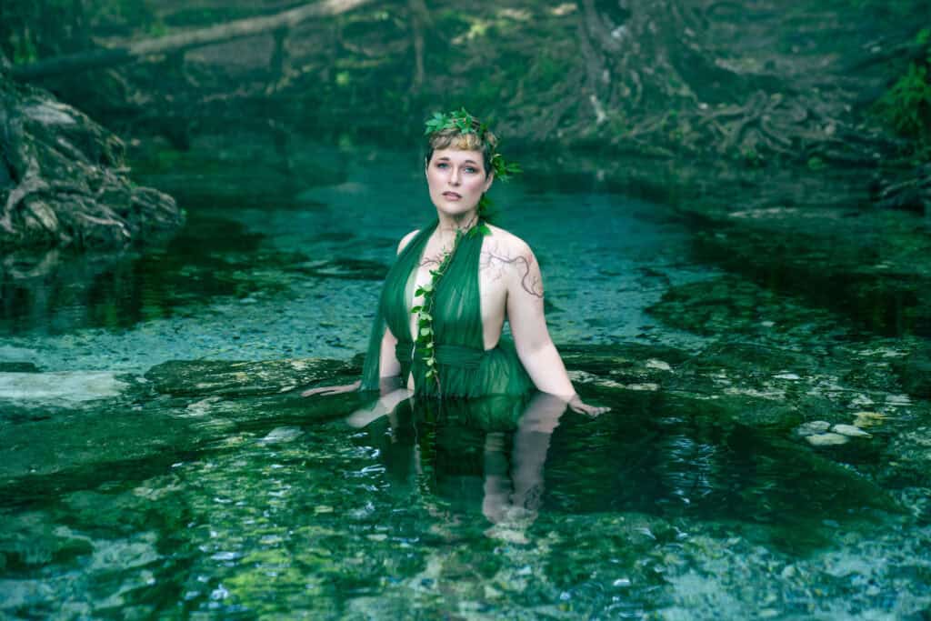 Woman in green dress poses in Florida spring