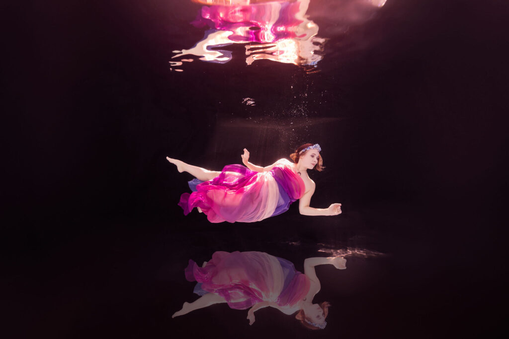Underwater portrait in pink dress showcasing one-on-one coaching results