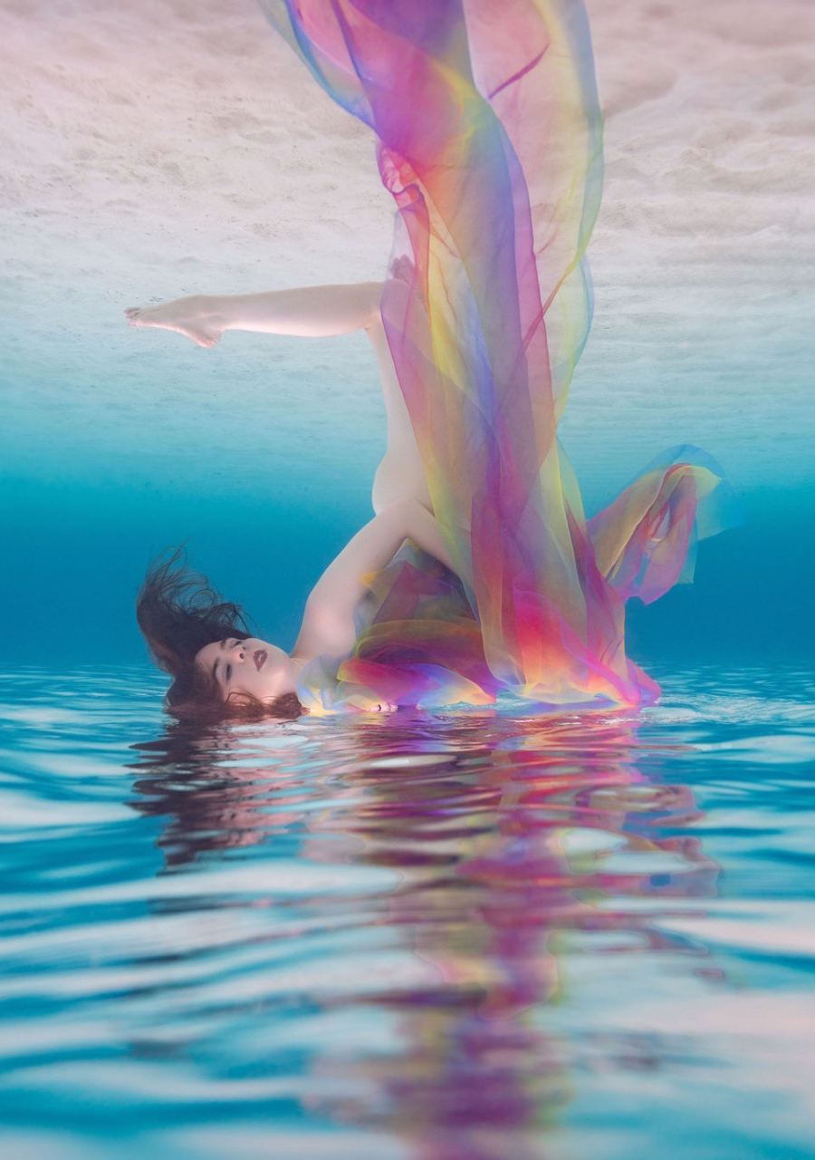 Flowing yellow gown drifting during an underwater portrait