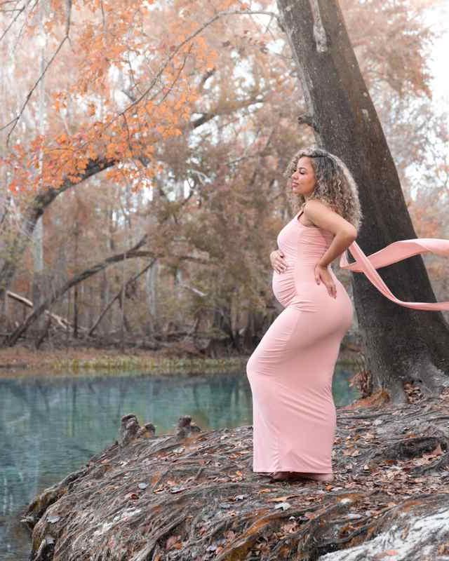 Expecting mother in a fitted blush maternity dress at a Florida spring