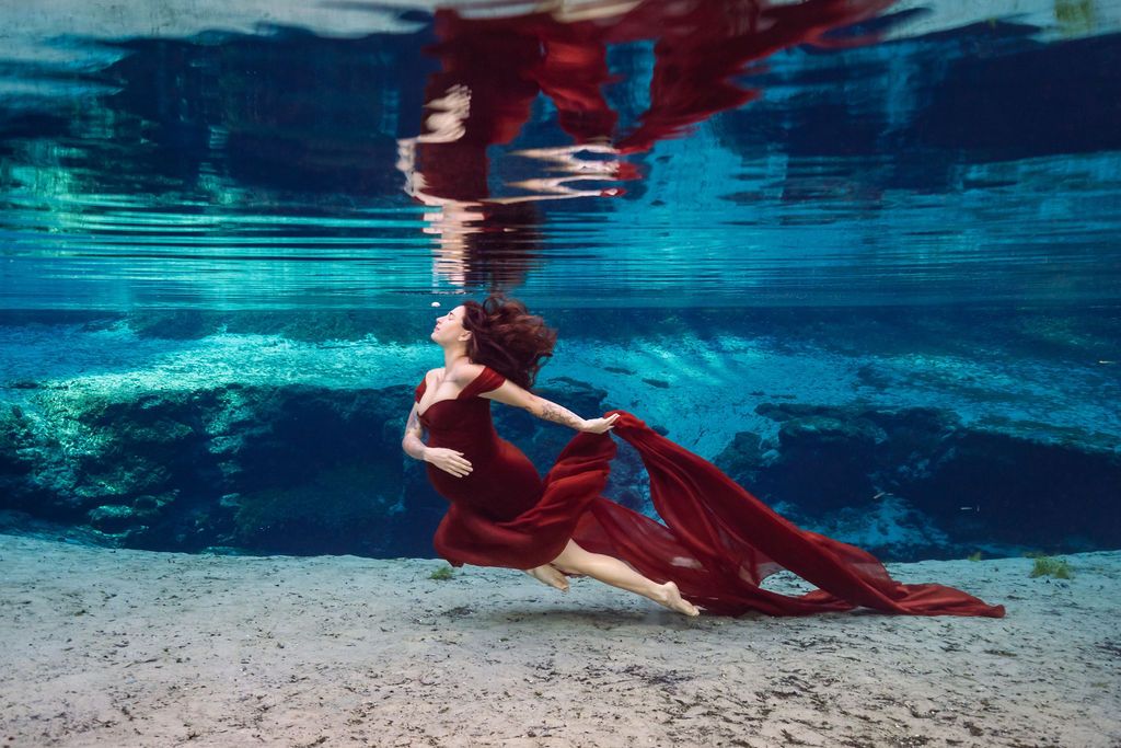 Expecting mother photographed underwater at a Florida spring during a maternity photoshoot