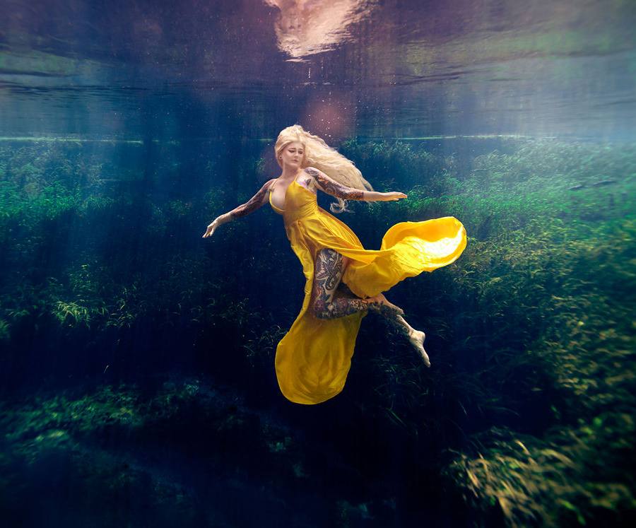 Woman in yellow dress underwater
