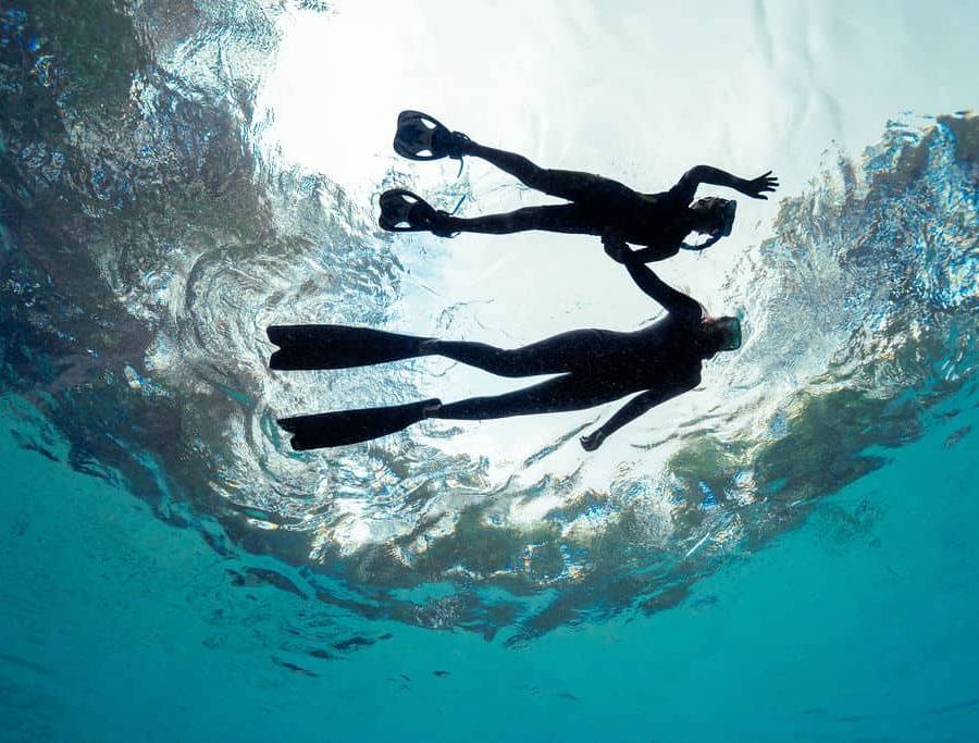 Mother and son snorkeling on the surface of a Florida Spring.