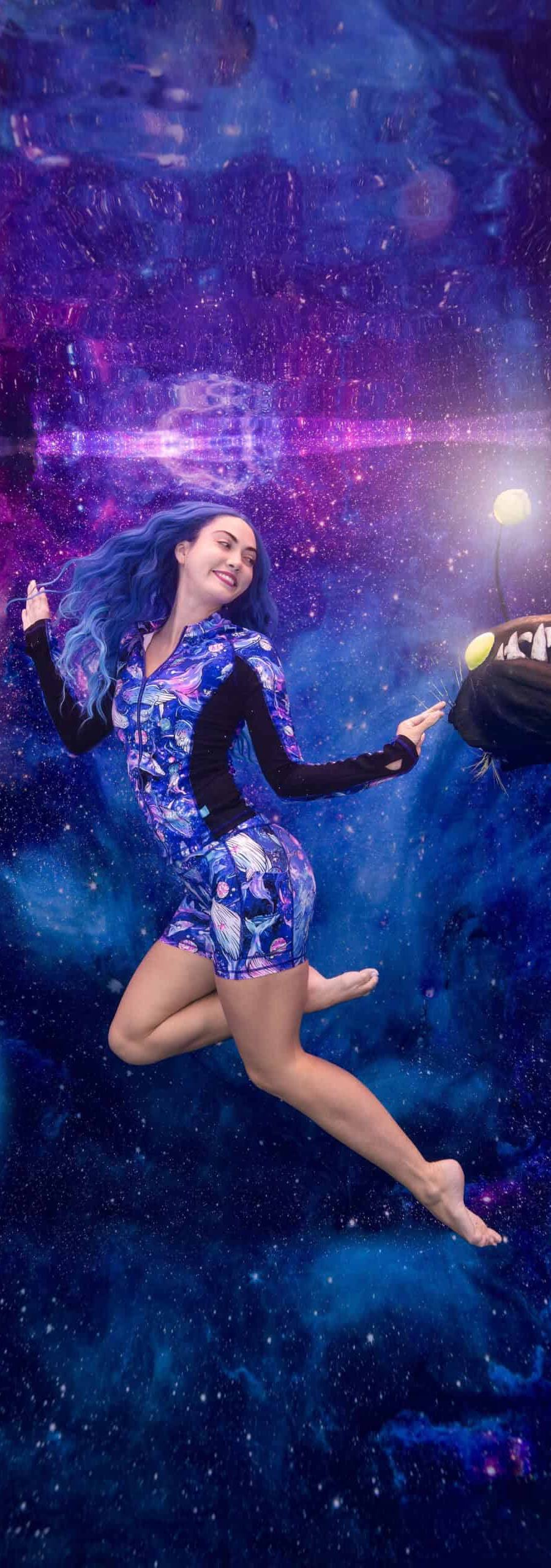 Model poses and interacts with a fake anglerfish for a commercial underwater photoshoot for Spacefish Army clothing and apparel.