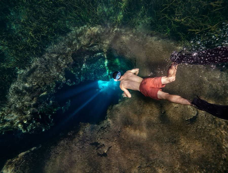 Freediver rests at the edge of the sinkhole for Blue Hole at Ichetucknee Springs State Park.