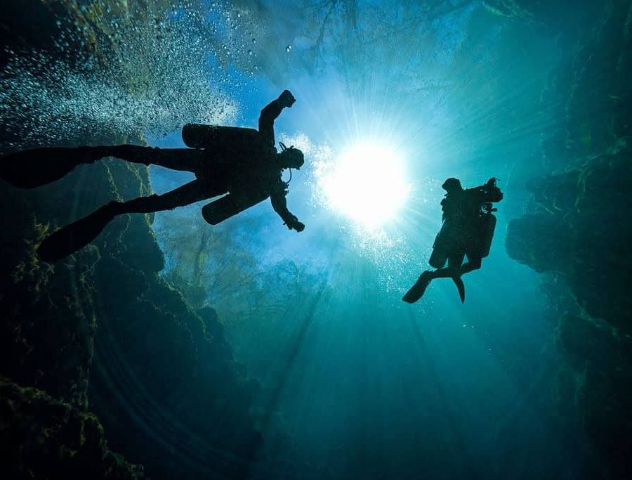Two cave divers descend into Orange Grove sink at Wes Skyles Peacock Springs State Park.