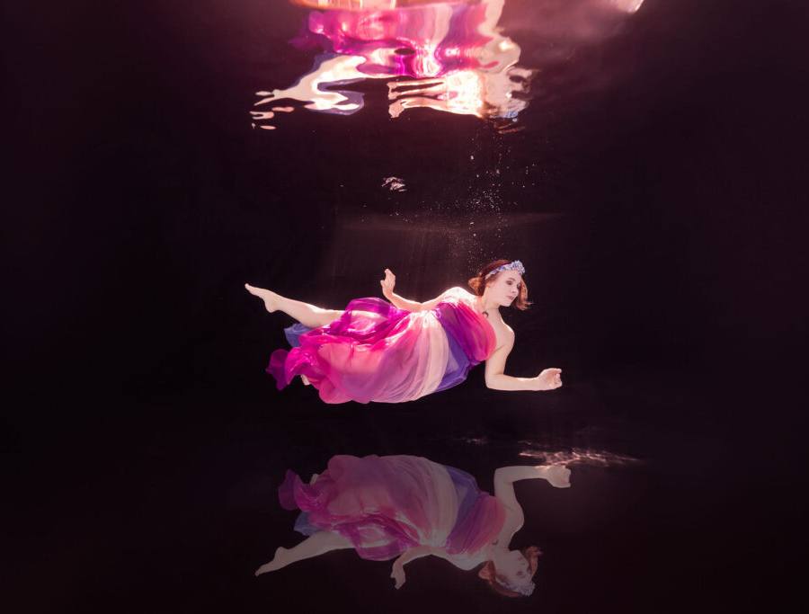 Underwater model in golden dress